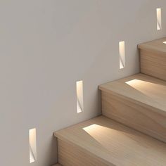 the light is shining through the windows on the wall next to the stair treads