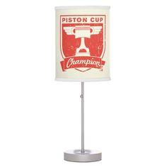 a lamp that is on top of a white base with a red and white logo