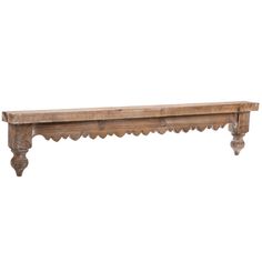 an old wooden bench with scalloped legs on a white background for display purposes