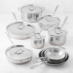 an assortment of stainless steel pots and pans