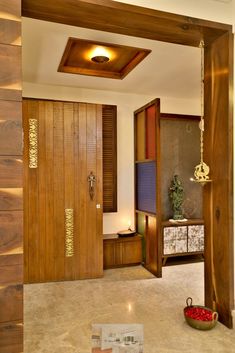 an open door leading to a living room with wood paneling on the walls and floor