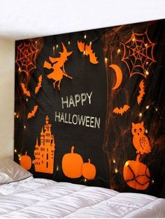 a halloween scene with pumpkins, bats and witch's web on the wall