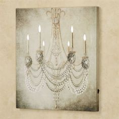 a chandelier hanging on the wall with candles