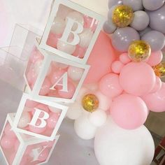 balloons and letters are on display at a baby shower