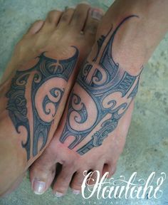 two people with tattoos on their feet and one is holding the other's leg