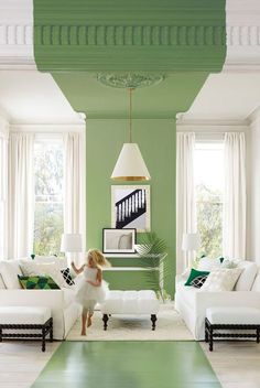 a living room with green walls and white furniture in the center is an image of a dog