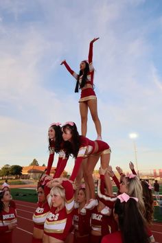 the cheerleaders are all dressed in red and white