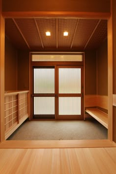 an empty room with sliding doors and shelves