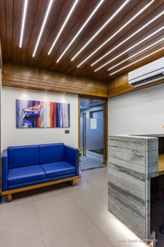 a blue couch sitting in the middle of a room next to a wooden counter top