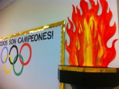 the olympic flame is on display in front of a sign that says olympics campeones