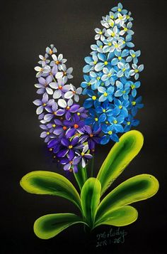 three blue and purple flowers on a black background