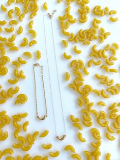 "Giving back is baked right into every Delicacies purchase! This purchase provides 40 meals to help fight hunger. This \"mini\" macaroni necklace comes with a 16\" chain that is adjustable to 15\". (Because of its dainty size, it is supposed to be worn higher up on the collarbone and is perfect for layering with other necklaces!) Each piece of Delicacies Jewelry comes \"gift wrapped\" in its own tiny mason jar, complete with an ingredient mythology card. (A special gift for yourself, or a loved Macaroni Necklace, Drawing Help, Food Jewelry, Magical Wedding, Foodie Gifts, Polish Jewelry, Mason Jar, Special Gift, Macaroni