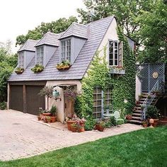 a house covered in vines and potted plants