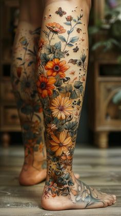 a woman's legs with flowers and butterflies on them, all over her body