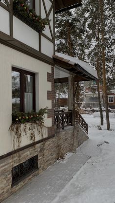 a house with snow on the ground and trees