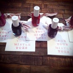 four bottles of nail polish sitting on top of each other next to two small note cards