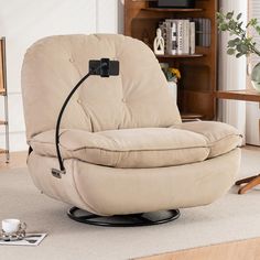 a living room with a recliner chair in the middle and a coffee cup on the floor next to it