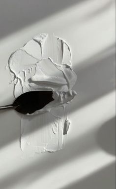 a paintbrush is being dipped with white paint