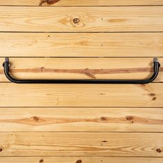 a wooden wall with a metal handle on it