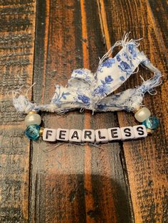 the word fearless is spelled with beads and fabric