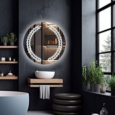 a bathroom with black walls and a round mirror on the wall above a white sink