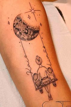 a couple sitting on a bench looking at the moon and stars in the sky tattoo