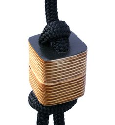 a wooden block tied to a black rope with a knot on it's end