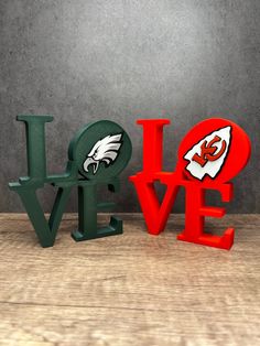 the word love is made out of letters with an eagle and football helmet on them