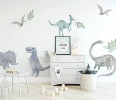 the dinosaur wall decals are on display in this child's room