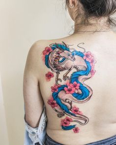 a woman with a dragon tattoo on her back