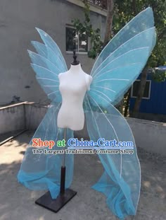 a mannequin dressed as a blue fairy tale butterfly, with wings spread out