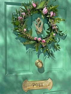 a green door with a wreath on it