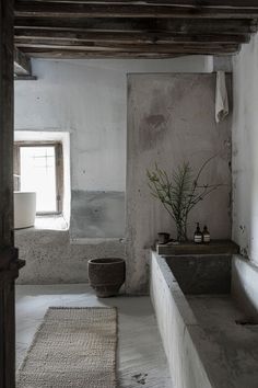 a bathroom with a sink, toilet and bathtub in the corner next to a window