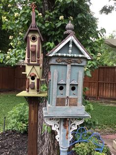 two bird houses are sitting on the side of a tree