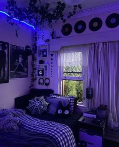 a bedroom decorated in purple and black for halloween