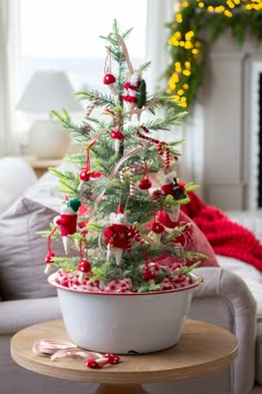 a decorated christmas tree in a bowl on a table