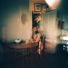 a dining room table and chairs in front of an open door with shutters on the side