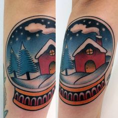 two snow globes with houses and trees in them on both legs, one is red and the other is blue