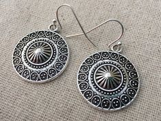 These are unique and highly detailed boho disc earrings.  They have a unique eye catching design and would be perfect for everyday wear.They measure 7/8" across by 1" long and hang from simple elegant ear wires.  The earrings are made from allergy free plated silver.I have a matching necklace in my shop, if you would like the whole set.  Here is the link........... https://etsy.me/2X6CB2r Thanks for stopping by.  Please take a moment and visit the rest of my shop.  I have many more unique jewelr Southwestern Style Festival Earrings, Southwestern Style Round Festival Earrings, Southwestern Style Festival Round Earrings, Nickel-free Southwestern Style Festival Earrings, Bohemian Circle Earrings, Round Festival Earrings, Bohemian Circle Earrings With Ear Wire, Adjustable Round Bohemian Plug Earrings, Festival Earrings With Oxidized Finish