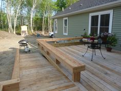 a wooden deck in front of a house