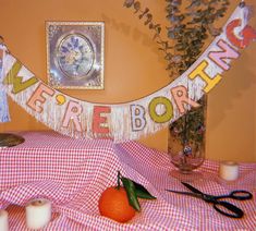 there is a sign that says happy birthday on the table next to some oranges