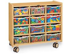 a wooden toy storage unit filled with lots of colorful plastic bins and toys on wheels