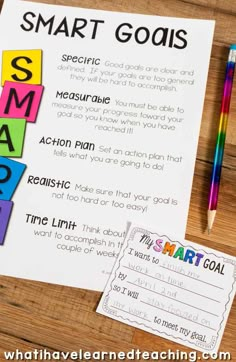 the smart goal worksheet is on top of a wooden table with pens and pencils