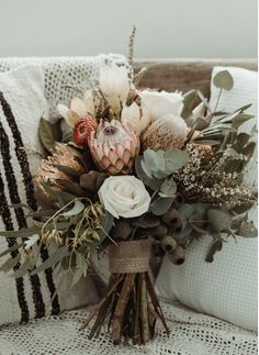 a bouquet of flowers sitting on top of a couch