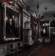 an ornate room with paintings and chandeliers