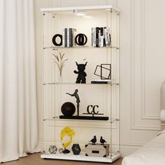 a white shelf filled with lots of books and knick knacks on top of it