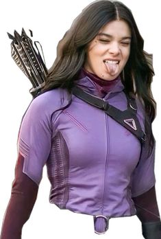 a woman wearing a purple shirt and black gloves with arrows on her shoulder, making a funny face