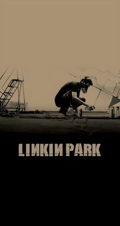 a man kneeling down on top of a skateboard next to a building with the words linkin park above him