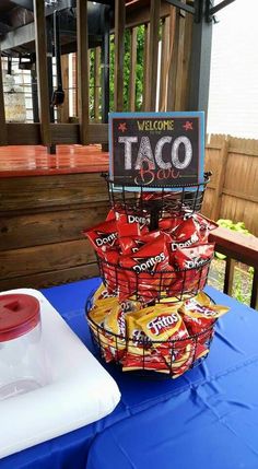 a blue table topped with lots of taco bags