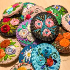 there are many different colored flowers on these small pieces of fabric that have been sewn together